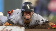 Chicago White Sox left fielder Andrew Benintendi (23) slides into third base against the Minnesota Twin at Target Field. 
