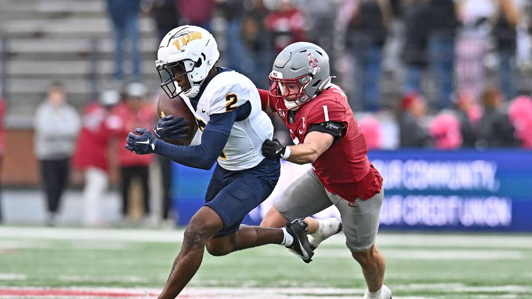 Oct 25, 2025; Pullman, Washington, USA; Toledo Rockets wide receiver Junior Vandeross III (2) makes a catch against Washington State Cougars safety Tucker Large (1) in the second half at Gesa Field at Martin Stadium. Mandatory Credit: James Snook-Imagn Images