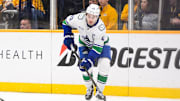 Jan 29, 2025; Nashville, Tennessee, USA;  Vancouver Canucks defenseman Quinn Hughes (43) skates behind the net against the Nashville Predators during the third period at Bridgestone Arena. Mandatory Credit: Steve Roberts-Imagn Images