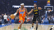 Nov 11, 2025; Oklahoma City, Oklahoma, USA; Oklahoma City Thunder guard Shai Gilgeous-Alexander (2) moves the ball down the court beside Golden State Warriors forward Jonathan Kuminga (1) during the first quarter at Paycom Center. Mandatory Credit: Alonzo Adams-Imagn Images 