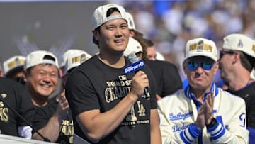 Nov 1, 2024; Los Angeles, CA, USA;  Los Angeles Dodgers owner Stan Kasten applauds as designated hitter Shohei Ohtani speaks to fans, in English, during the World Series Championship Celebration at Dodger Stadium. 