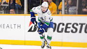 Jan 29, 2025; Nashville, Tennessee, USA;  Vancouver Canucks defenseman Quinn Hughes (43) skates behind the net against the Nashville Predators during the third period at Bridgestone Arena. Mandatory Credit: Steve Roberts-Imagn Images