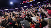 Georgia fans storm the court after the Bulldogs beat No. 3 Florida.