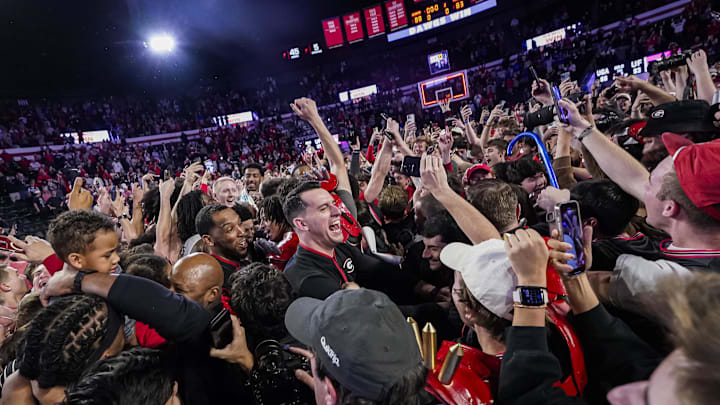 Georgia fans storm the court after the Bulldogs beat No. 3 Florida.
