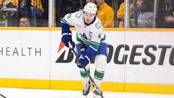 Jan 29, 2025; Nashville, Tennessee, USA;  Vancouver Canucks defenseman Quinn Hughes (43) skates behind the net against the Nashville Predators during the third period at Bridgestone Arena. Mandatory Credit: Steve Roberts-Imagn Images