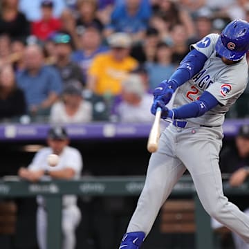 Sep 13, 2024; Denver, Colorado, USA; Chicago Cubs right fielder Cody Bellinger (24) hits a two RBI single in the first inning against the Colorado Rockies at Coors Field.