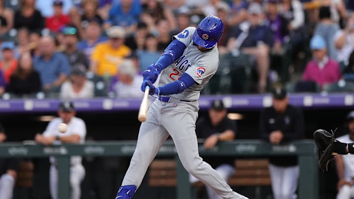 Sep 13, 2024; Denver, Colorado, USA; Chicago Cubs right fielder Cody Bellinger (24) hits a two RBI single in the first inning against the Colorado Rockies at Coors Field.