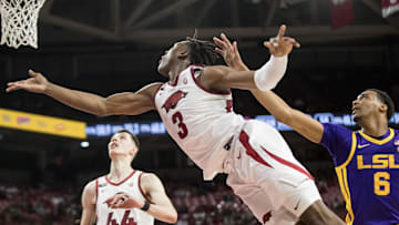 Feb 12, 2025; Fayetteville, Arkansas, USA;  Arkansas Razorbacks forward Adou Thiero (3) puts up an underhanded shot past LSU Tigers forward Robert Miller III (6) during the second half at Bud Walton Arena. Arkansas won 70-58. Mandatory Credit: Brett Rojo-Imagn Images
