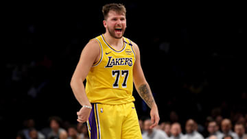 Mar 10, 2025; Brooklyn, New York, USA; Los Angeles Lakers guard Luka Doncic (77) reacts after a three point shot against the Brooklyn Nets during the second quarter at Barclays Center. Mandatory Credit: Brad Penner-Imagn Images