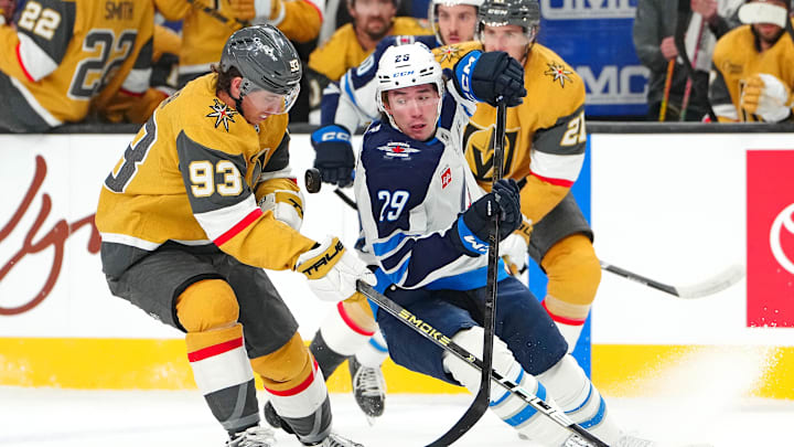 Apr 13, 2026; Las Vegas, Nevada, USA; Winnipeg Jets center Brayden Yager (29) eyes a loose puck in front of Vegas Golden Knights right wing Mitch Marner (93) during the first period at T-Mobile Arena. Mandatory Credit: Stephen R. Sylvanie-Imagn Images