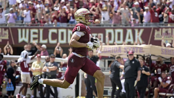 Sep 6, 2025; Tallahassee, Florida, USA; Florida State Seminoles wide receiver Duce Robinson (0) catches a touchdown during the first half against the East Texas A&M at Doak S. Campbell Stadium. Mandatory Credit: Melina Myers-Imagn Images