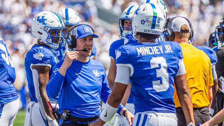 Sep 5, 2026; Lexington, Kentucky, USA;  Kentucky Wildcats head coach Will Stein talks to Kentucky Wildcats quarterback Kenny Minchey (3) during a time out during the first quarter against the Youngstown State Penguins at Kroger Field.  Mandatory Credit: Arden Barnes-Imagn Images
