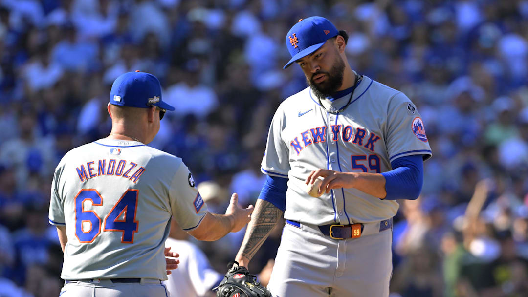 Oct 14, 2024; Los Angeles, California, USA; New York Mets manager Carlos Mendoza (64) relieves pitcher Sean Manaea (59) in the sixth inning against the Los Angeles Dodgers during game two of the NLCS for the 2024 MLB Playoffs at Dodger Stadium. Mandatory Credit: Jayne Kamin-Oncea-Imagn Images