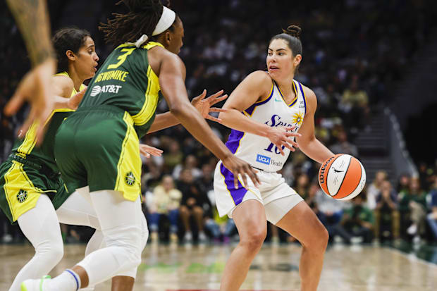 Sparks guard Kelsey Plum (10) looks to pass away from a double tieam from Seattle Storm guard Skylar Diggins
