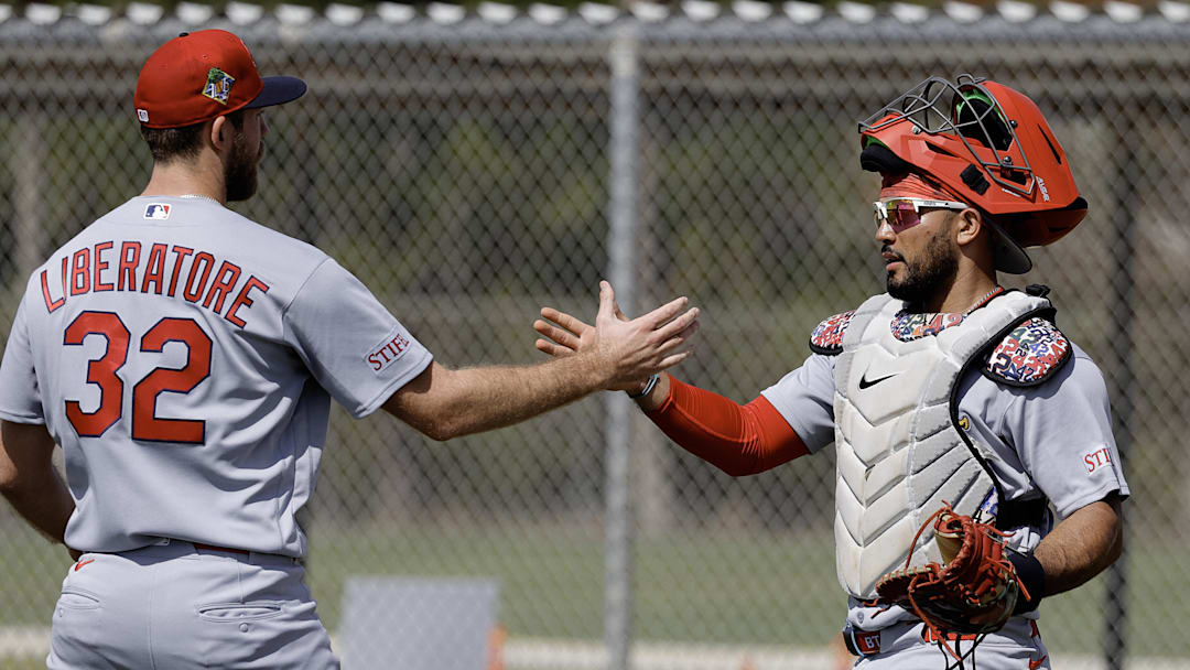 Feb 16, 2026; Jupiter, FL, USA;  St. Louis Cardinals catcher Iván Herrera (right) and pitcher Matthew Liberatore (32) shake hands after pitching drills during spring training workouts at Roger Dean Stadium. Mandatory Credit: Reinhold Matay-Imagn Images