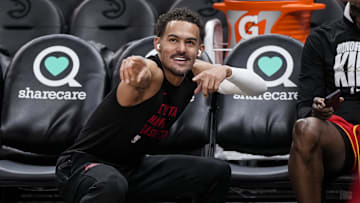 Atlanta Hawks guard Trae Young reacts with a fan he passed the ball to on the court prior to the game