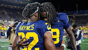 Michigan quarterback Bryce Underwood (19) hugs running back Justice Haynes (22) on the field after 34-17 win at Michigan Stadium in Ann Arbor on Saturday, August 30, 2025.