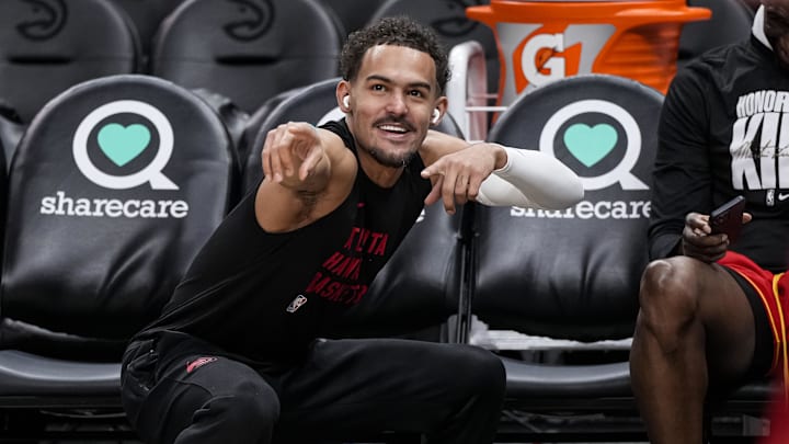 Atlanta Hawks guard Trae Young reacts with a fan he passed the ball to on the court prior to the game