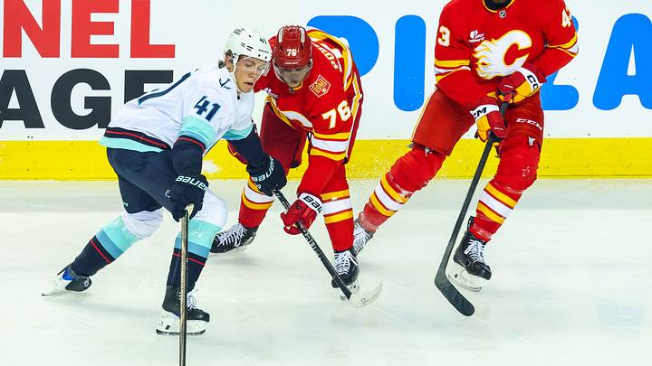 Oct 1, 2026; Calgary, Alberta, CAN; Seattle Kraken defenseman Ryker Evans (41) controls the puck against the Calgary Flames during the first period at Scotiabank Saddledome. Mandatory Credit: Sergei Belski-Imagn Images