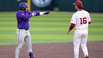 LSU's Luis Hernandez (23) celebrates a double next to Oklahoma's Dayton Tockey (16) during the college baseball game between the University of Oklahoma Sooners and the LSU Tigers at L. Dale Mitchell Park in Norman, Okla., Thursday, April, 3, 2025.