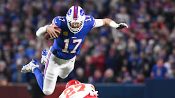 Nov 17, 2024; Orchard Park, New York, USA; Buffalo Bills quarterback Josh Allen (17) leaps over Kansas City Chiefs safety Chamarri Conner (27) to get a first down at Highmark Stadium. Mandatory Credit: Mark Konezny-Imagn Images