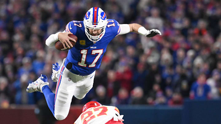 Nov 17, 2024; Orchard Park, New York, USA; Buffalo Bills quarterback Josh Allen (17) leaps over Kansas City Chiefs safety Chamarri Conner (27) to get a first down at Highmark Stadium. Mandatory Credit: Mark Konezny-Imagn Images