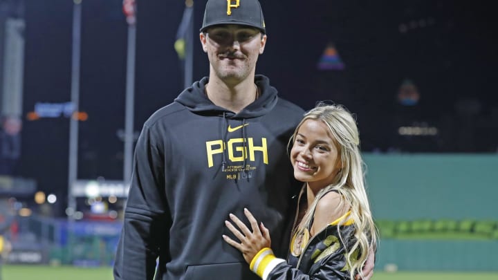 Pittsburgh Pirates starting pitcher Paul Skenes (30) poses with his girlfriend Louisiana State University gymnast Olivia Dunn (right) after making his major league debut against the Chicago Cubs at PNC Park on May 11.