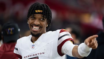 Sep 29, 2024; Glendale, Arizona, USA; Washington Commanders quarterback Jayden Daniels (5) celebrates against the Arizona Cardinals at State Farm Stadium. Mandatory Credit: Mark J. Rebilas-Imagn Images
