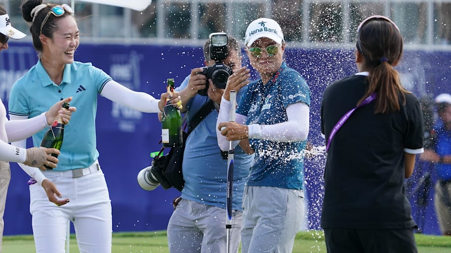 Lee got champagne celebration on the 18th green after her win. | Raymond Carlin III-Imagn Images