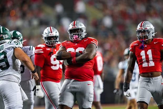 Ohio State Buckeyes DT Kayden McDonald celebrates after sacking Ohio Bobcats quarterback Nick Poulos.