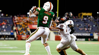 Dec 29, 2020; Orlando, FL, USA; Miami Hurricanes tight end Brevin Jordan (9) makes a reception for a touchdown in front of Oklahoma State Cowboys linebacker Malcolm Rodriguez (20) during the second half of the Cheez-It Bowl Game at Camping World Stadium. Mandatory Credit: Douglas DeFelice-Imagn Images