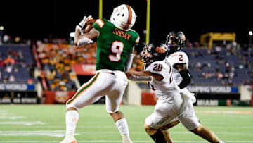 Dec 29, 2020; Orlando, FL, USA; Miami Hurricanes tight end Brevin Jordan (9) makes a reception for a touchdown in front of Oklahoma State Cowboys linebacker Malcolm Rodriguez (20) during the second half of the Cheez-It Bowl Game at Camping World Stadium. Mandatory Credit: Douglas DeFelice-Imagn Images