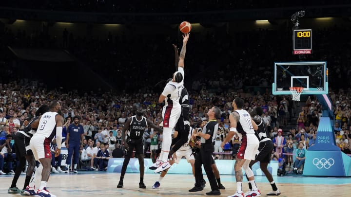 Jul 31, 2024; Villeneuve-d'Ascq, France; United States center Anthony Davis (14) reaches for the opening tip in the first quarter against South Sudan during the Paris 2024 Olympic Summer Games at Stade Pierre-Mauroy. 