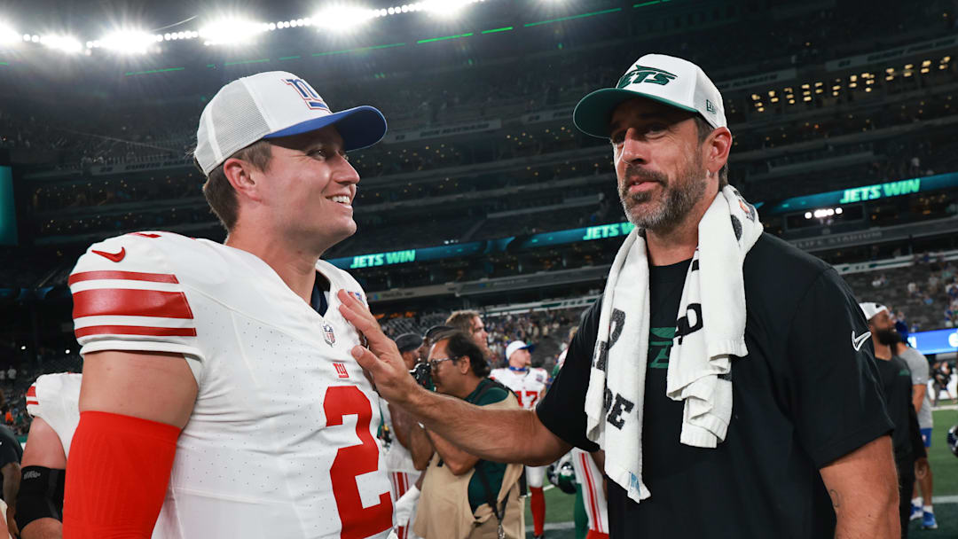 Aug 24, 2024; East Rutherford, New Jersey, USA; New York Jets quarterback Aaron Rodgers (8) talks with New York Giants quarterback Drew Lock (2) after the game at MetLife Stadium. Mandatory Credit: Vincent Carchietta-Imagn Images