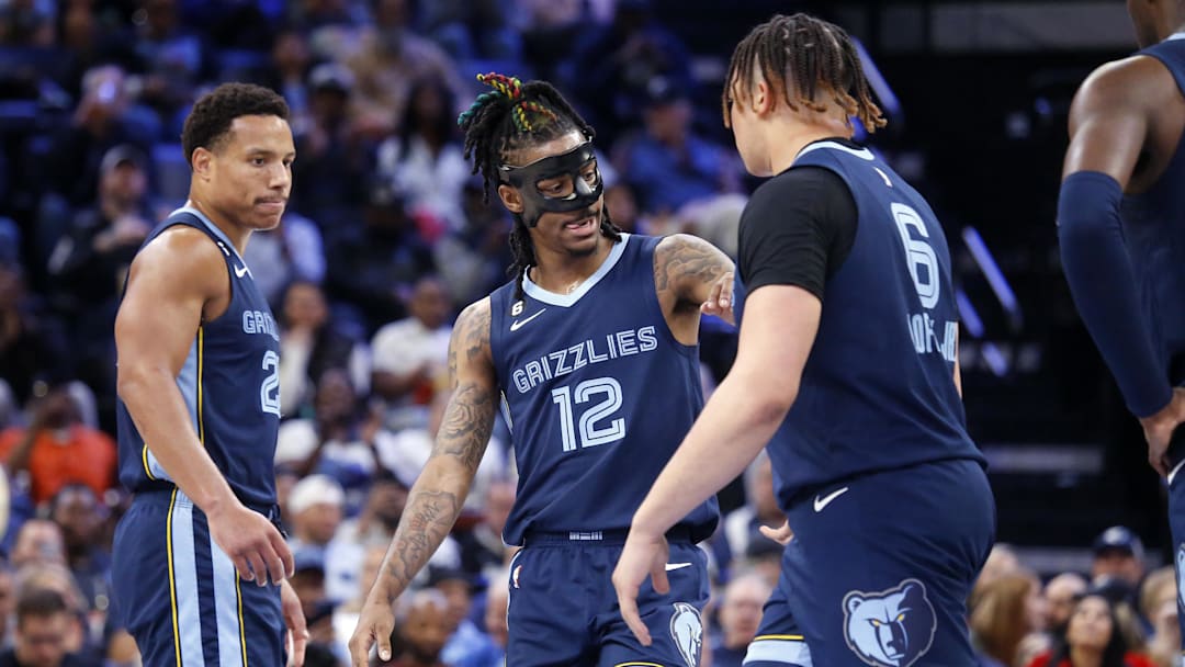 Mar 22, 2023; Memphis, Tennessee, USA; Memphis Grizzlies guard Ja Morant (12) reacts with forward Kenneth Lofton Jr. (6) during the first half against the Houston Rockets at FedExForum. Mandatory Credit: Petre Thomas-Imagn Images