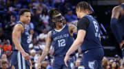 Mar 22, 2023; Memphis, Tennessee, USA; Memphis Grizzlies guard Ja Morant (12) reacts with forward Kenneth Lofton Jr. (6) during the first half against the Houston Rockets at FedExForum. Mandatory Credit: 