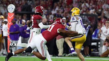 Nov 8, 2025; Tuscaloosa, Alabama, USA; Louisiana State Tigers quarterback Garrett Nussmeier (18) under pressure from Alabama Crimson Tide linebacker Deontae Lawson (0) and defensive lineman Keon Keeley (31) during the second quarter of the game at Saban Field at Bryant-Denny Stadium. Mandatory Credit: David Leong-Imagn Images
