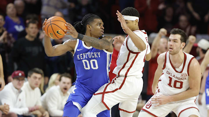 Feb 26, 2025; Norman, Oklahoma, USA; Oklahoma Sooners guard Jeremiah Fears (0) defends Kentucky Wildcats guard Otega Oweh (00) during the second half at Lloyd Noble Center. Mandatory Credit: Alonzo Adams-Imagn Images
