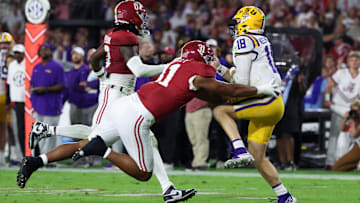 Nov 8, 2025; Tuscaloosa, Alabama, USA; Louisiana State Tigers quarterback Garrett Nussmeier (18) under pressure from Alabama Crimson Tide linebacker Deontae Lawson (0) and defensive lineman Keon Keeley (31) during the second quarter of the game at Saban Field at Bryant-Denny Stadium. Mandatory Credit: David Leong-Imagn Images