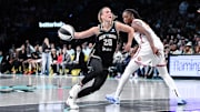 Jun 1, 2025; Brooklyn, New York, USA; New York Liberty guard Sabrina Ionescu (20) drives past Connecticut Sun center Tina Charles (31) during the second half at Barclays Center. Mandatory Credit: John Jones-Imagn Images
