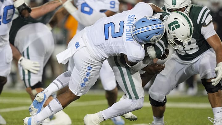 Sep 6, 2025; Charlotte, North Carolina, USA; Charlotte 49ers quarterback Conner Harrell (15) is tackled by North Carolina Tar Heels linebacker Andrew Simpson (2) for a sack during the second half at Jerry Richardson Stadium. Mandatory Credit: Jim Dedmon-Imagn Images