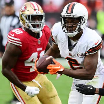 Oct 15, 2023; Cleveland, Ohio, USA; Cleveland Browns wide receiver Amari Cooper (2) runs with the ball after a catch as San Francisco 49ers cornerback Deommodore Lenoir (2) and linebacker Oren Burks (48) defend during the second half at Cleveland Browns Stadium. Mandatory Credit: Ken Blaze-USA TODAY Sports