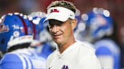 Mississippi Rebels head coach Lane Kiffin watches pregame warmups against the Florida Gators at Vaught-Hemingway Stadium. 