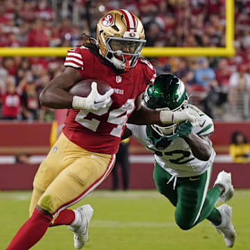 Sep 9, 2024; Santa Clara, California, USA; San Francisco 49ers running back Jordan Mason (24) rushes by New York Jets safety Tony Adams (22) in the fourth quarter at Levi's Stadium. Mandatory Credit: David Gonzales-Imagn Images