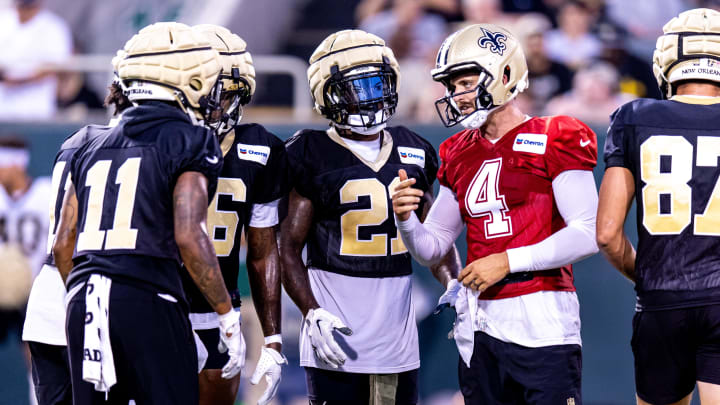 Aug 20, 2024; New Orleans, LA, USA;  New Orleans Saints quarterback Derek Carr (4) calls play in the huddle with wide receiver Cedrick Wilson Jr. (11) and running back Jamaal Williams (21) during practice at Yulman Stadium (Tulane). Mandatory Credit: Stephen Lew-USA TODAY Sports