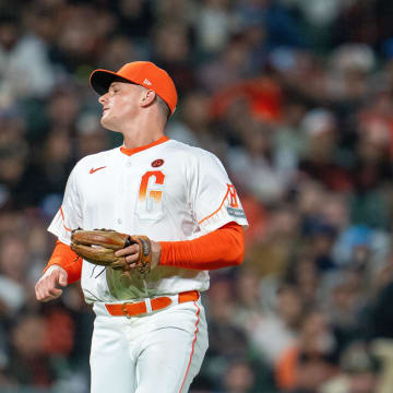 Jul 30, 2024; San Francisco, California, USA;  San Francisco Giants third baseman Matt Chapman (26) reacts after the error fielding a ground ball against the Oakland Athletics during the eighth inning at Oracle Park.