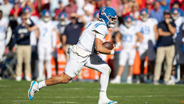 Nov 23, 2024; Gainesville, Florida, USA; Mississippi Rebels quarterback Jaxson Dart (2) runs with the ball against the Florida Gators during the second half at Ben Hill Griffin Stadium. Mandatory Credit: Matt Pendleton-Imagn Images