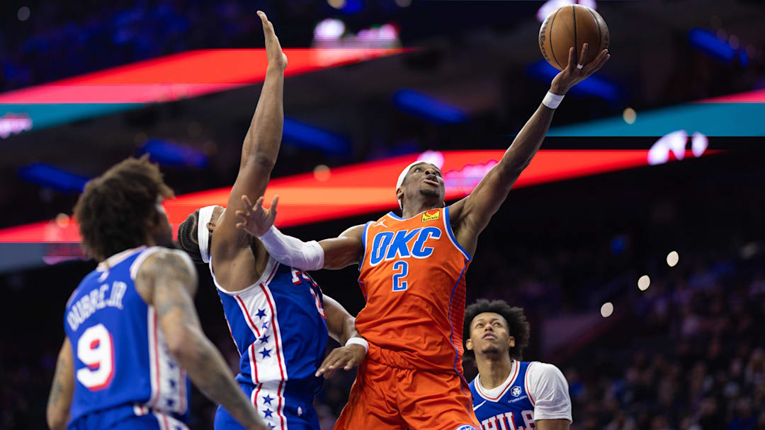 Jan 14, 2025; Philadelphia, Pennsylvania, USA; Oklahoma City Thunder guard Shai Gilgeous-Alexander (2) drives for a shot past Philadelphia 76ers forward Guerschon Yabusele (28) during the third quarter at Wells Fargo Center. Mandatory Credit: Bill Streicher-Imagn Images
