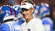 Mississippi Rebels head coach Lane Kiffin watches pregame warmups against the Florida Gators at Vaught-Hemingway Stadium.
