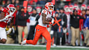 Nov 23, 2024; Piscataway, New Jersey, USA; Illinois Fighting Illini wide receiver Pat Bryant (13) gains yards after catch as linebacker Dariel Djabome (28) pursues during the second half at SHI Stadium. Mandatory Credit: Vincent Carchietta-Imagn Images